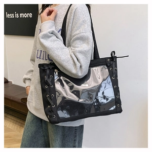 Detail of black tote bag with silver mirror panel and ribbon bows on the side