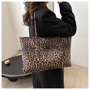 Detail of high-capacity leopard print tote bag on shoulder for urban commute fashion