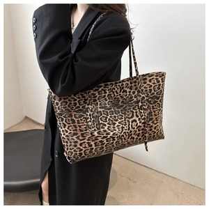 Fashionable leopard print tote bag with large capacity worn with a black blazer