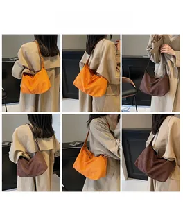 Diverse vedute della borsa tote grande in camoscio arancione e marrone indossata