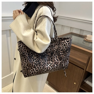 Macro detail of the leopard print pattern and premium texture on this large tote bag