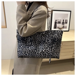Close-up of leopard print tote bag styled with a wool coat for a chic daily commute