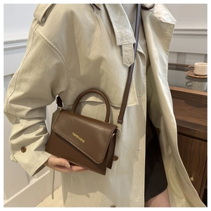 Detailed view of the brown leather mini crossbody bag with Fashion & Bags gold lettering