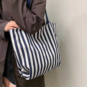 Large striped canvas tote bag in navy and white with durable shoulder straps for women