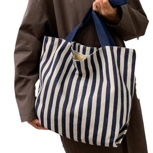 Minimalist blue and white striped canvas tote bag with navy blue handles for daily casual use
