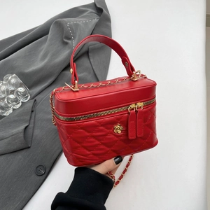 Chic red quilted leather handbag with gold flower clasp and chain strap for winter fashion