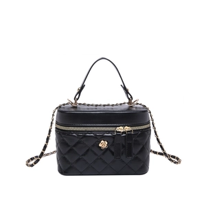 Black quilted crossbody bag with gold camellia floral ornament and chain strap
