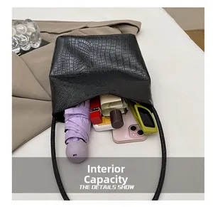 Top view of the black crocodile pattern bucket bag showing large interior storage capacity