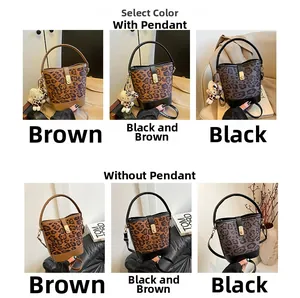 Detail view of leopard print bucket bags in three colors with metal clasps and straps