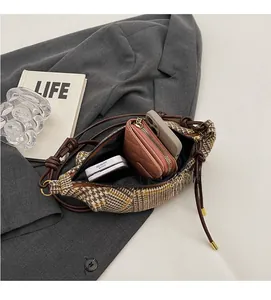 Detail showing spacious interior of the plaid knit bag with phone and wallet inside