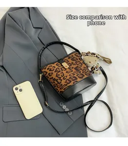 Leopard print bucket bag size comparison with a smartphone showing dimensions