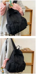 Macro shot of black nylon backpack side pocket and adjustable drawstring detail