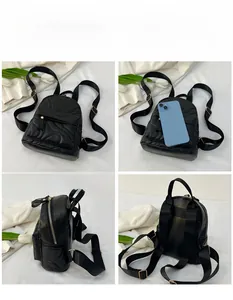 Detail view of the mini black quilted backpack with glossy texture and adjustable straps