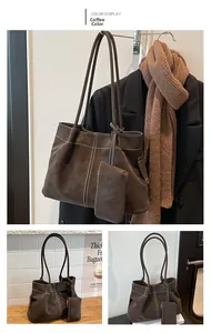Detailed view of coffee brown suede tote bag with white stitching and matching small pouch