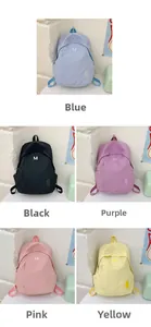 Detailed grid of minimalist nylon backpacks in blue, black, purple, pink and yellow with M logo