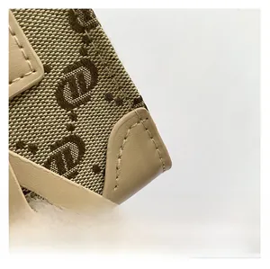 Macro detail of retro jacquard canvas fabric and premium khaki leather trim on handbag