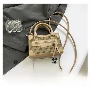Detailed top view of a mini square shoulder bag with smartphone for size reference