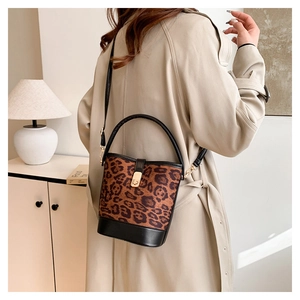 Fashion leopard print bucket bag with gold clasp and leather strap on model