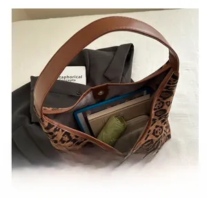 Detailed interior of leopard print tote bag showing large capacity for tablets and books