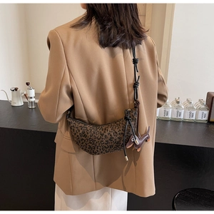 Leopard print crescent bag with stylish shoulder strap and cute puppy pendant accessory