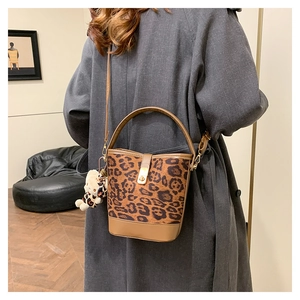 Fashionable leopard print bucket bag shown from behind with neutral coat outfit