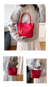 Detail view of mini red nylon tote bag with heart charm for casual Korean style outfits