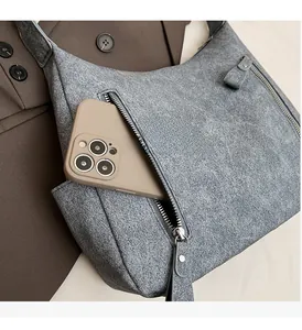 Detailed macro view showing the front zipper pocket capacity of this gray tote bag