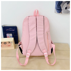 Pink nylon backpack detail showing wide shoulder straps and side zipper pocket