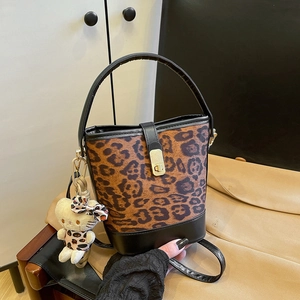 Fashionable leopard print bucket bag with black leather handle and cat plush pendant