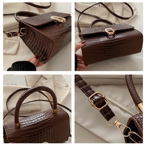 Detailed views of dark brown crocodile embossed leather bag with gold buckle hardware