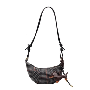 Houndstooth crescent shoulder bag with dog charm and knotted leather strap details