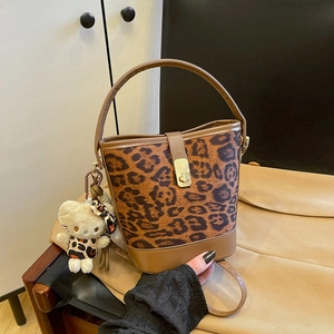 Chic leopard print bucket bag with brown leather trim and metallic twist lock closure