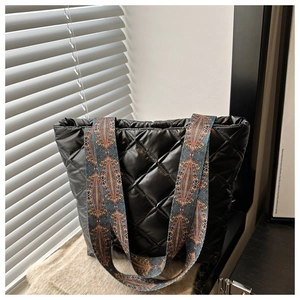 Détail du sac fourre-tout noir matelassé avec bandoulière tissée aux motifs ethniques