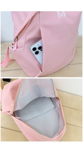 Detail view of the spacious pink backpack interior and easy-access side zipper pocket