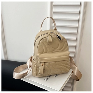 Detailed close-up of light khaki quilted PU backpack with multiple zipper pockets