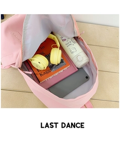 Internal view of spacious pink nylon backpack with books, tablet and headphones