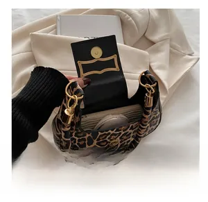 Detailed interior view of leopard print handbag showing capacity for phone and cosmetics
