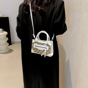 Minimalist white and brown monogram leather crossbody bag with tassel detail on model
