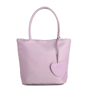 Minimalist purple nylon tote bag with heart charm and waterproof handles on white background