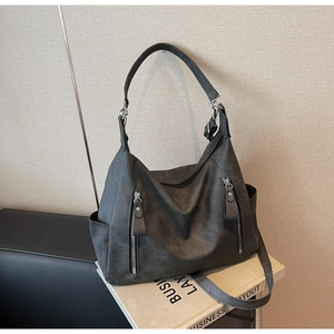 Close-up of dark grey frosted hobo bag with front zippers and adjustable strap