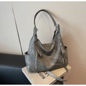 Macro detail of vintage matte gray tote bag with side pocket and zipper feature
