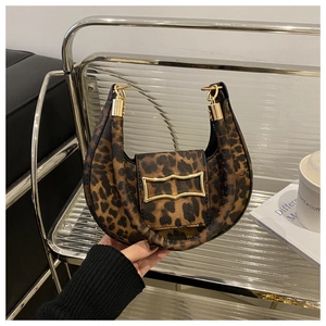 Close-up of leopard print crescent bag with polished gold buckle and premium texture