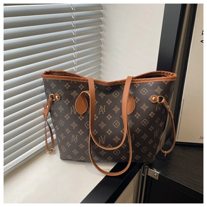 Detail of vintage monogram tote bag with brown faux leather trim and side drawstring