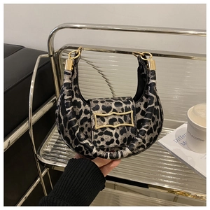 Close-up of leopard print crescent bag with stylish gold metal buckle and short strap