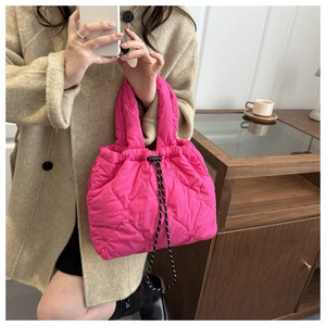 Detail of pink quilted heart pattern on bucket bag with stylish woven drawstring
