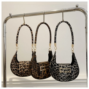 Detailed comparison of three leopard print crescent bags in brown, tan, and grey patterns