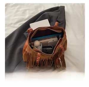 Internal view of brown faux suede bucket bag showing large capacity for daily items