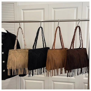 Detail view of suede fringe tote bags with braided straps in four neutral color options