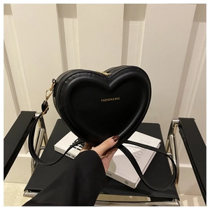 Detail of heart-shaped black leather bag with gold FASHION & BAG lettering and hardware