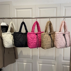 Quilted heart pattern tote bag in five colors with drawstring closure and soft handles